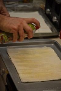 Gordon spraying each layer of filo dough_small