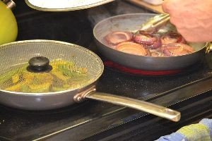 onions and peppers on the stove_small