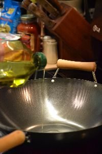 adding olive oil to a large wok_small