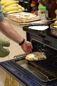 our naan bread pizzas in the oven_small