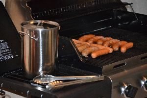placing the brats on the grill to cook_small