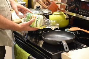 111 Gordon adding some cooking oil to a pan_small