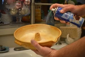 Gordon spraying the pottery with baking spray with flour in it_small