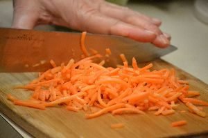 36 chopping the carrots on a cutting board_small